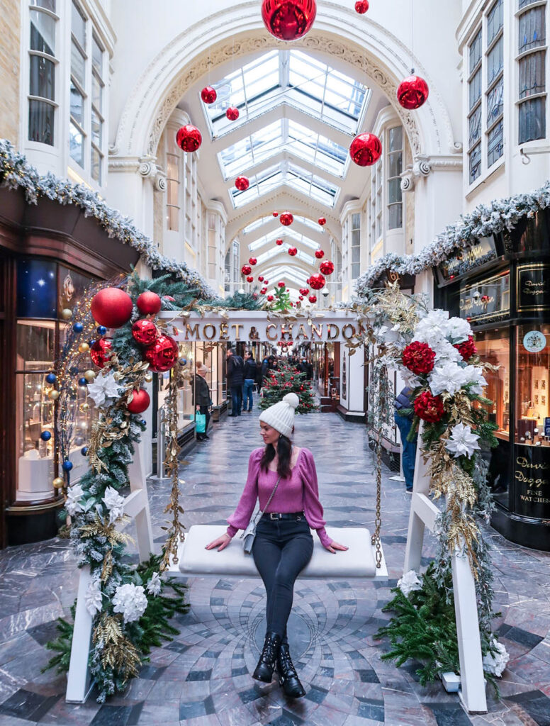 Amy sat on a Christmas swing in Burlington Arcade